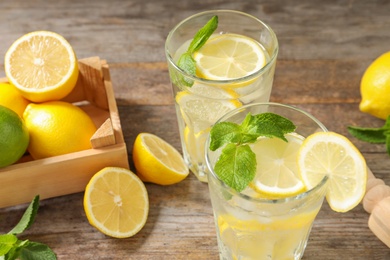 Glasses of natural lemonade with mint on table