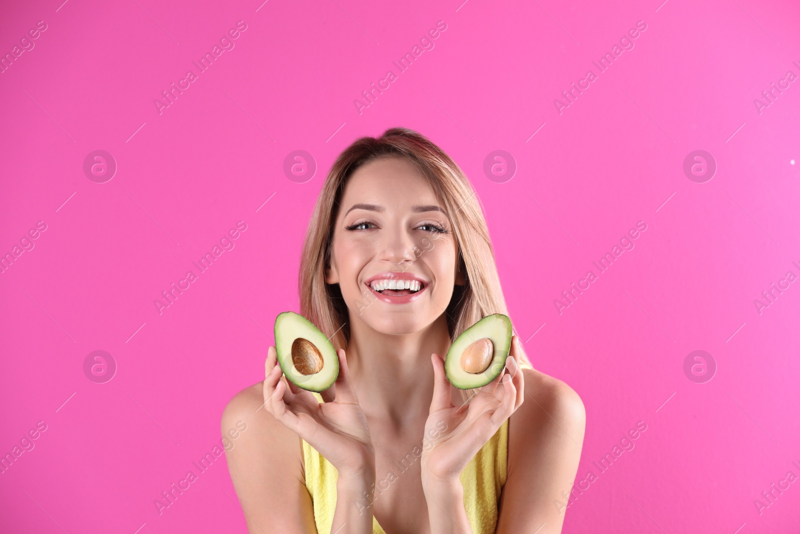 Photo of Portrait of young beautiful woman with ripe delicious avocado on color background