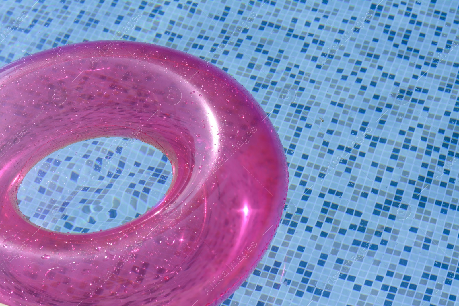 Photo of Inflatable ring floating on water in swimming pool