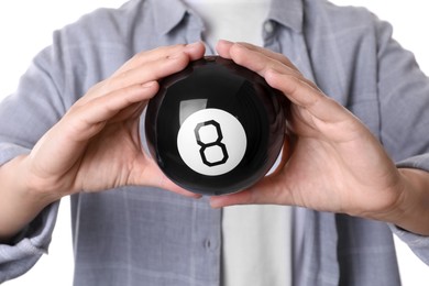 Woman holding magic eight ball on white background, closeup