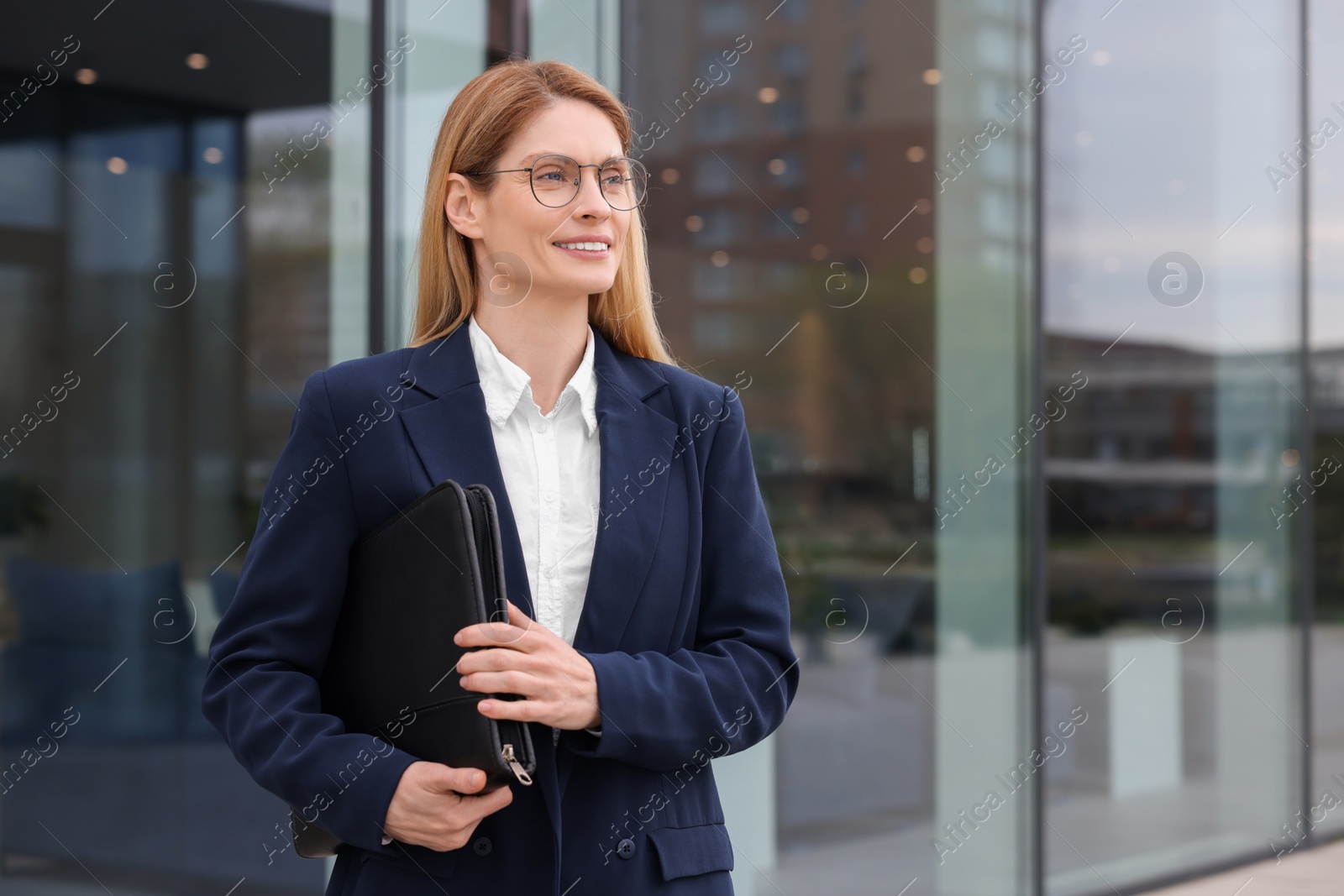 Photo of Real estate agent with leather portfolio outdoors. Space for text