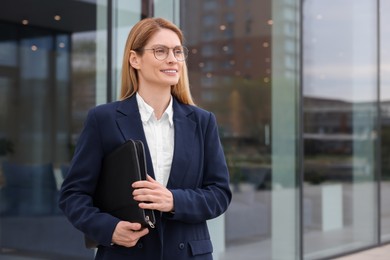 Photo of Real estate agent with leather portfolio outdoors. Space for text