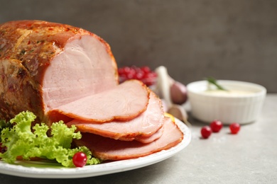 Delicious ham served with garnish on grey table, closeup