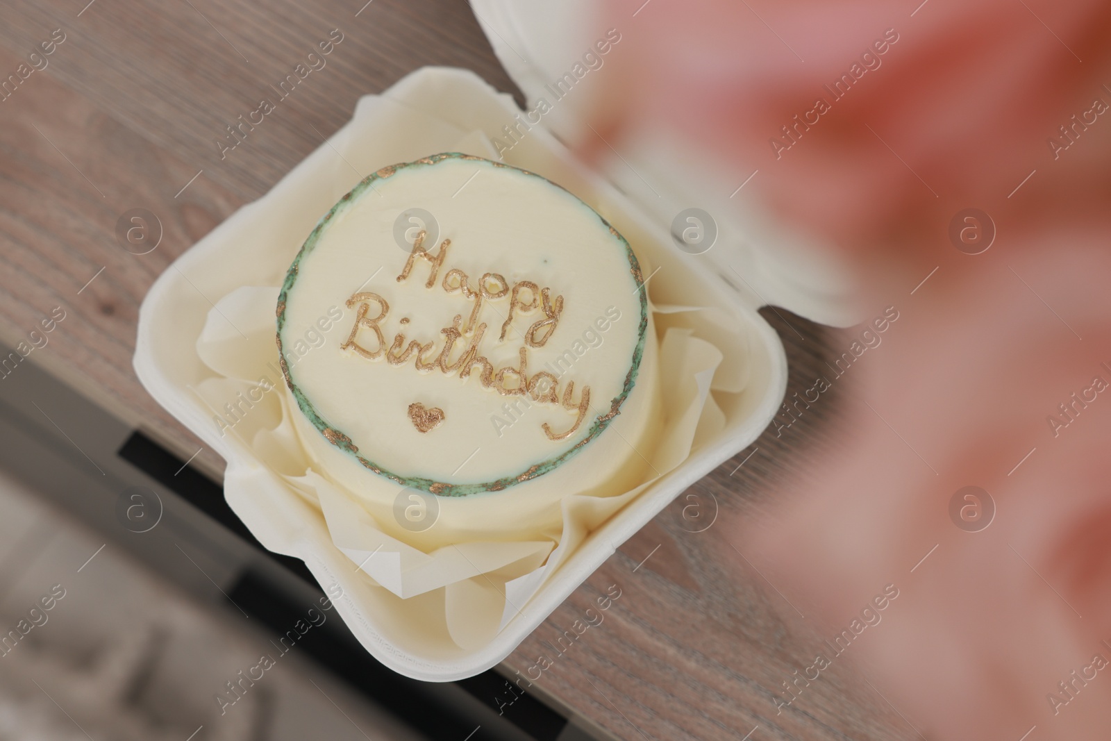 Photo of Delicious decorated Birthday cake on wooden surface indoors, above view