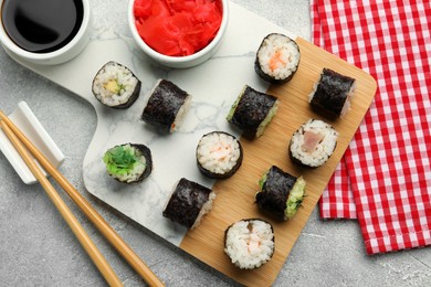 Photo of Flat lay composition with sushi rolls on grey table