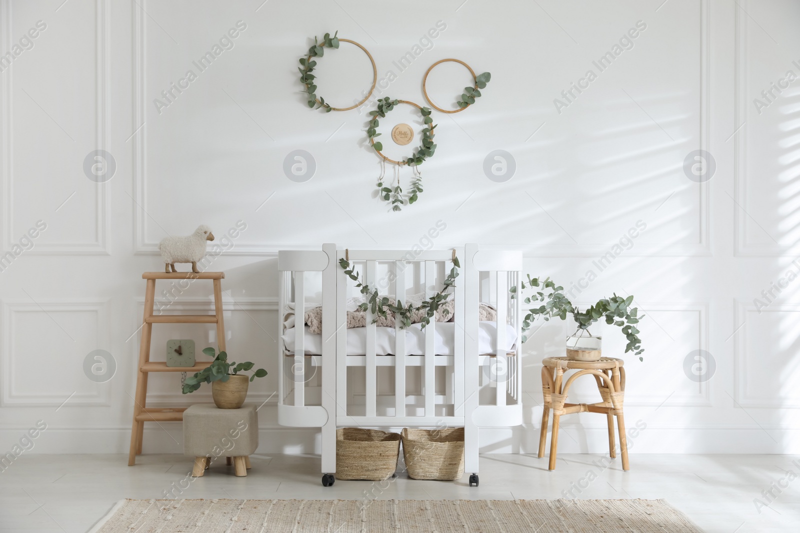 Photo of Stylish baby room decorated with eucalyptus branches