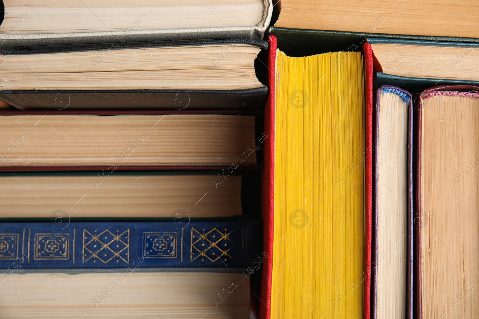 Photo of Stack of hardcover books as background, closeup