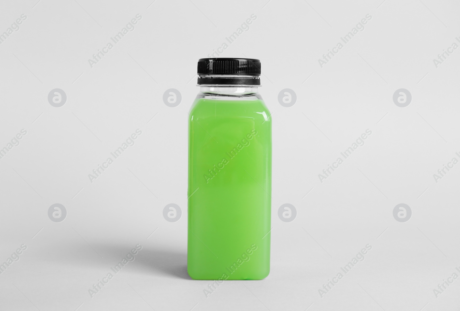 Photo of Bottle with delicious fresh juice on light background