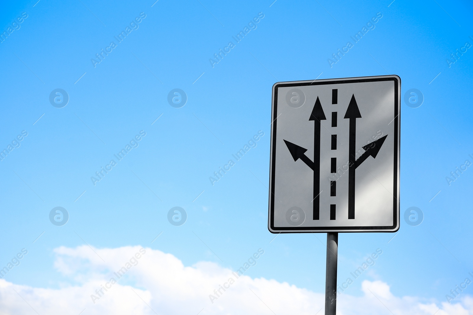 Photo of Post with road sign against cloudy sky. Space for text