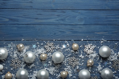 Flat lay composition with Christmas decorations on blue wooden background, space for text. Winter season