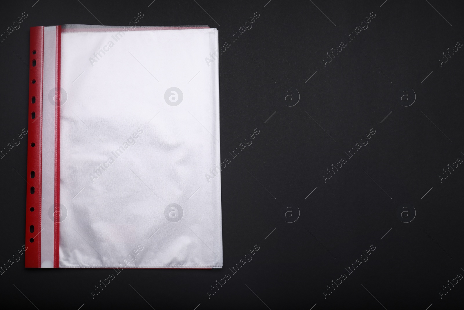 Photo of File folder with punched pockets on black background, flat lay. Space for text
