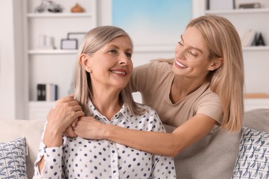 Happy mature mother and her daughter at home