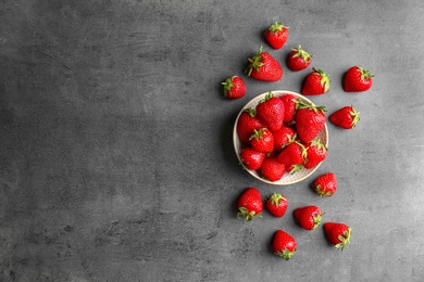 Flat lay composition with ripe red strawberries on grey background