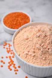 Lentil flour and seeds on white marble table, closeup