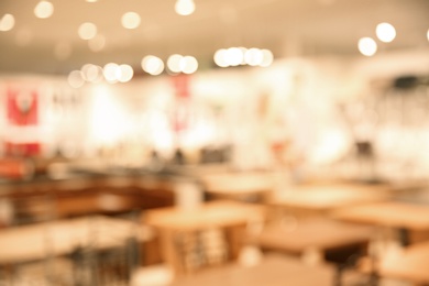 Photo of Blurred view of modern shopping mall interior