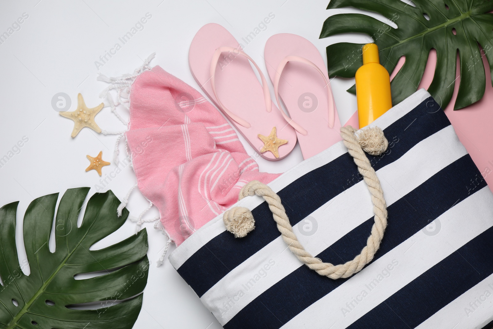 Photo of Stylish bag and beach accessories on color background, flat lay