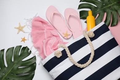 Stylish bag and beach accessories on color background, flat lay