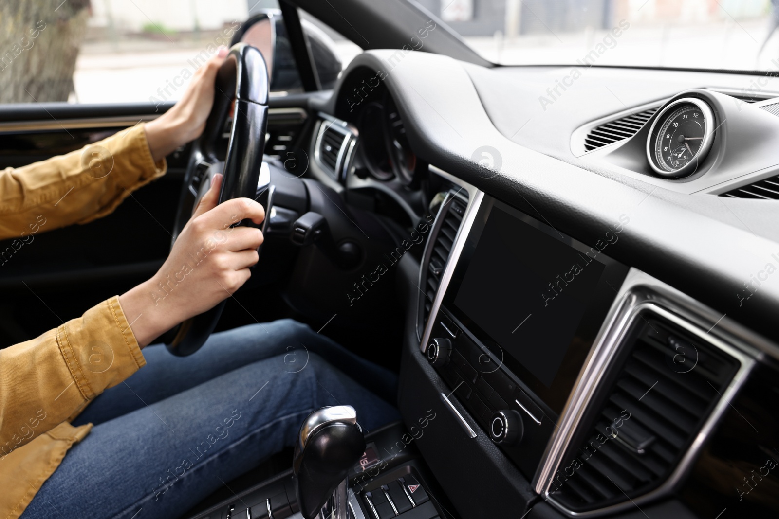 Photo of Woman using navigation system while driving her car, closeup