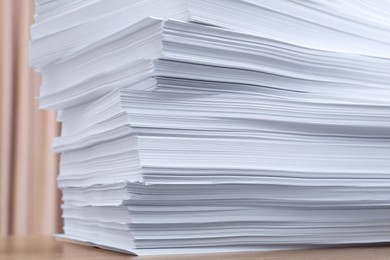 Stack of paper sheets on wooden table indoors, closeup