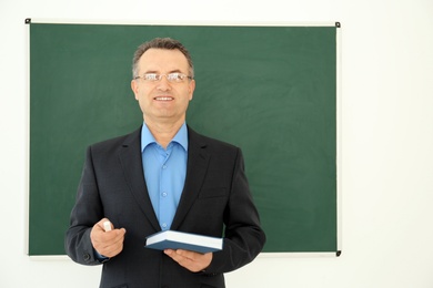 Photo of Portrait of male teacher in classroom