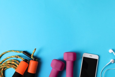 Photo of Flat lay composition with fitness gym equipment on color background. Space for text