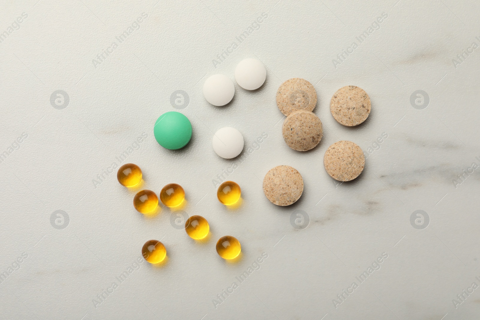 Photo of Different dietary supplements on white table, flat lay