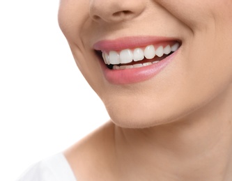 Young woman with beautiful smile on white background, closeup. Teeth whitening