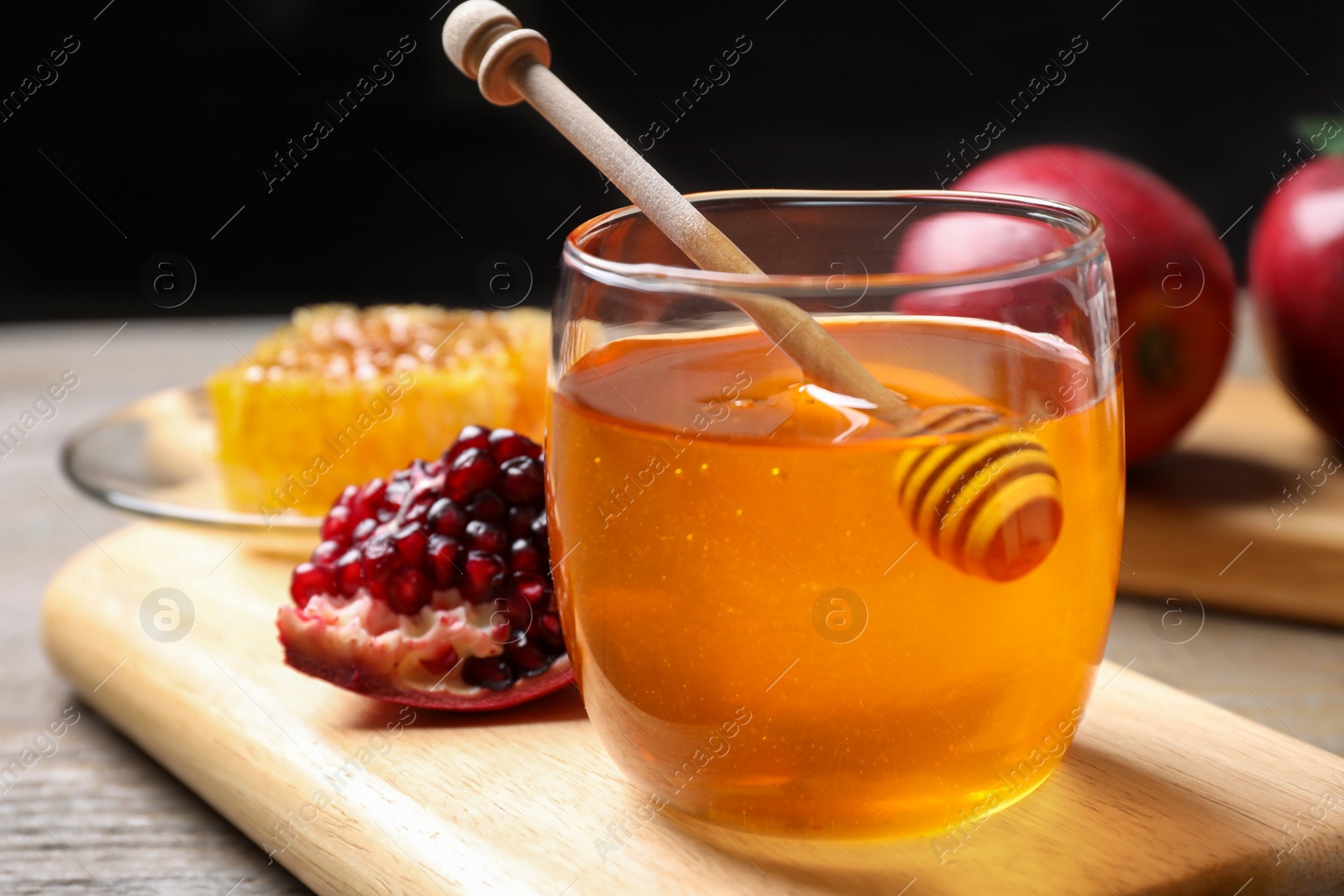Photo of Honey, apples and pomegranate on table. Rosh Hashanah holiday