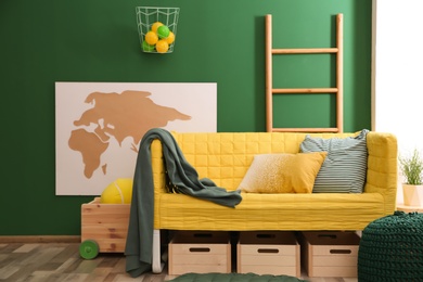 Modern room interior with sofa and wooden crates. Eco style