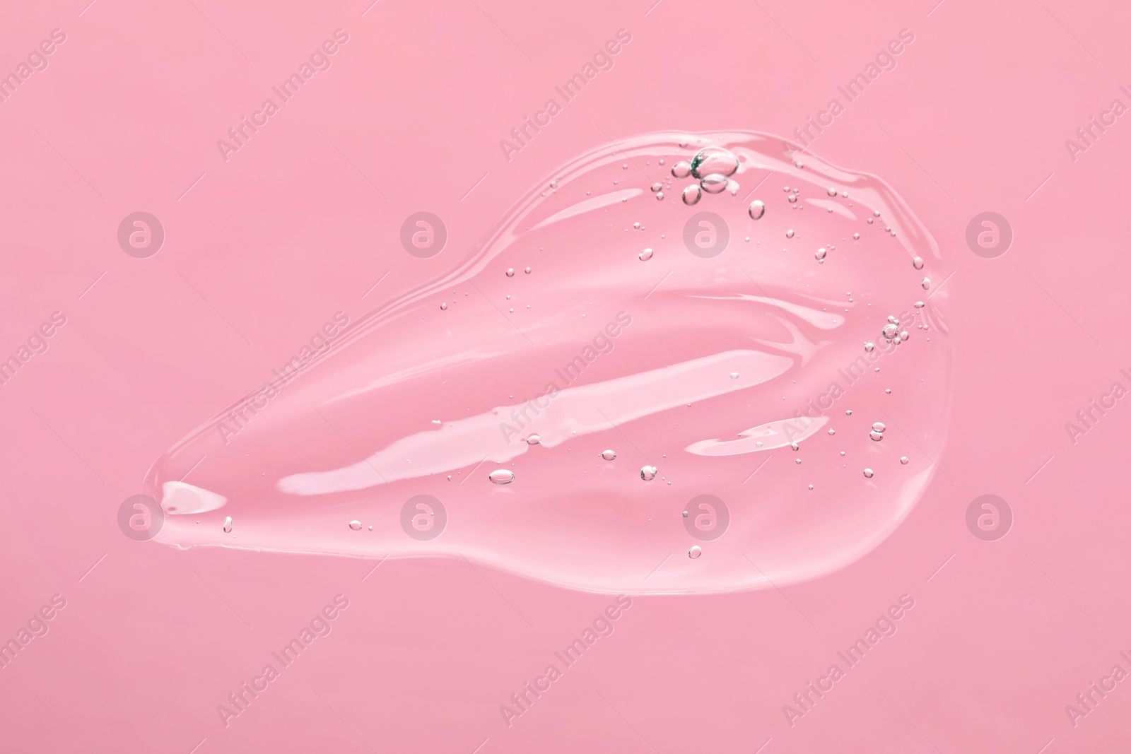 Photo of Sample of cleansing gel on light pink background, top view. Cosmetic product