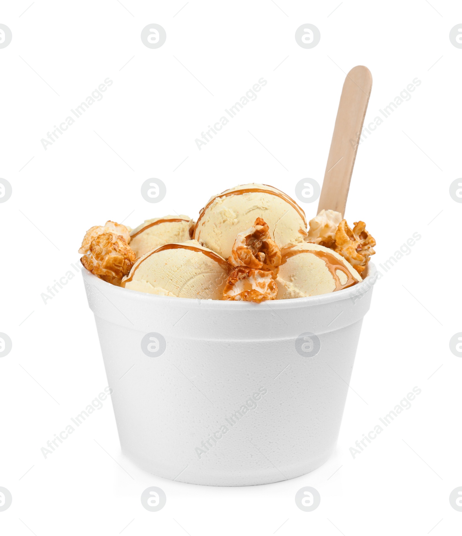 Photo of Delicious ice cream with caramel popcorn and sauce in dessert bowl on white background