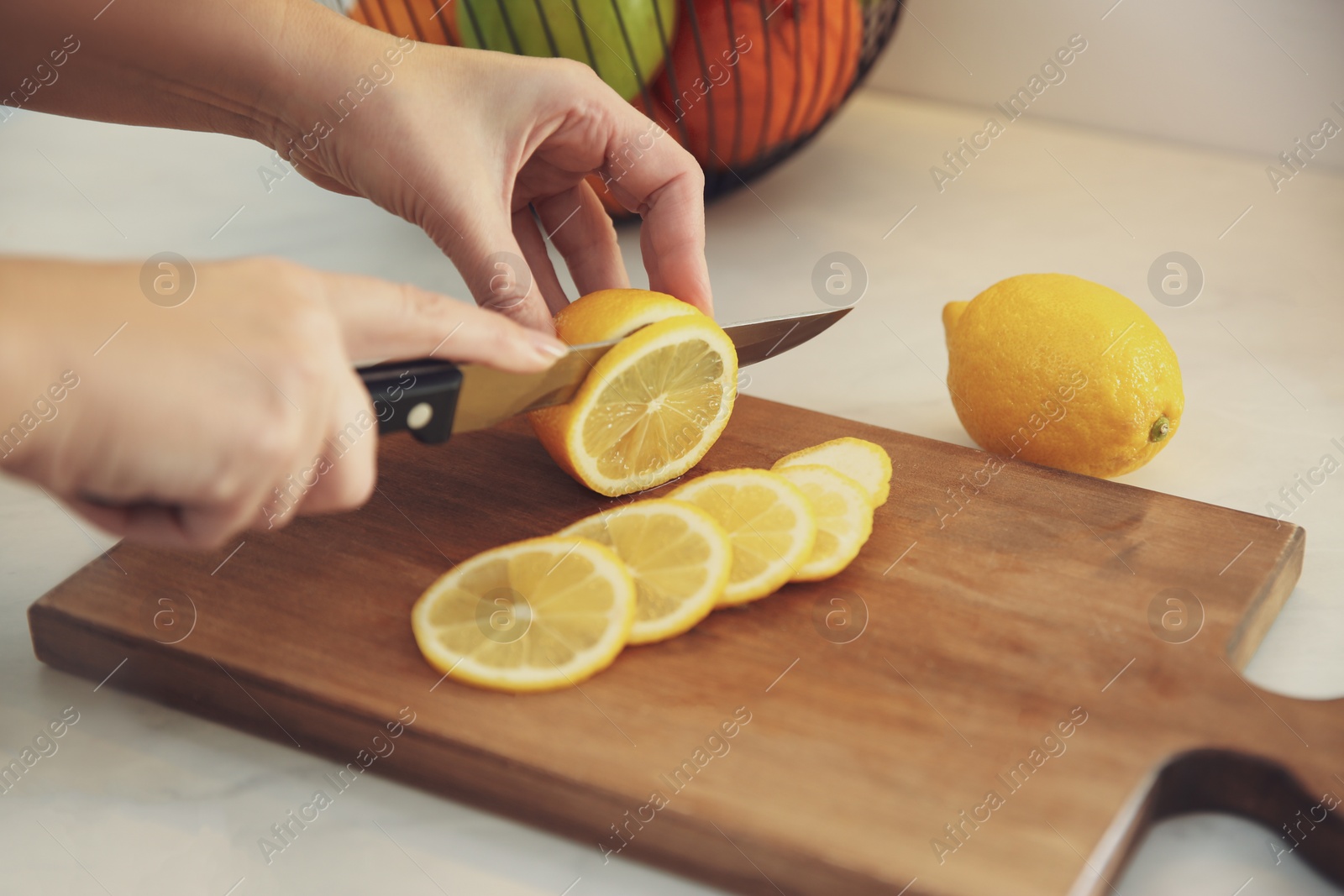 Photo of Woman cooking at table in kitchen, closeup