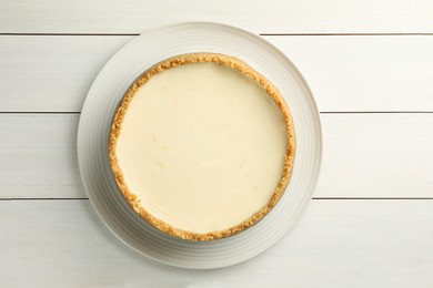 Photo of Tasty vegan tofu cheesecake on white wooden table, top view