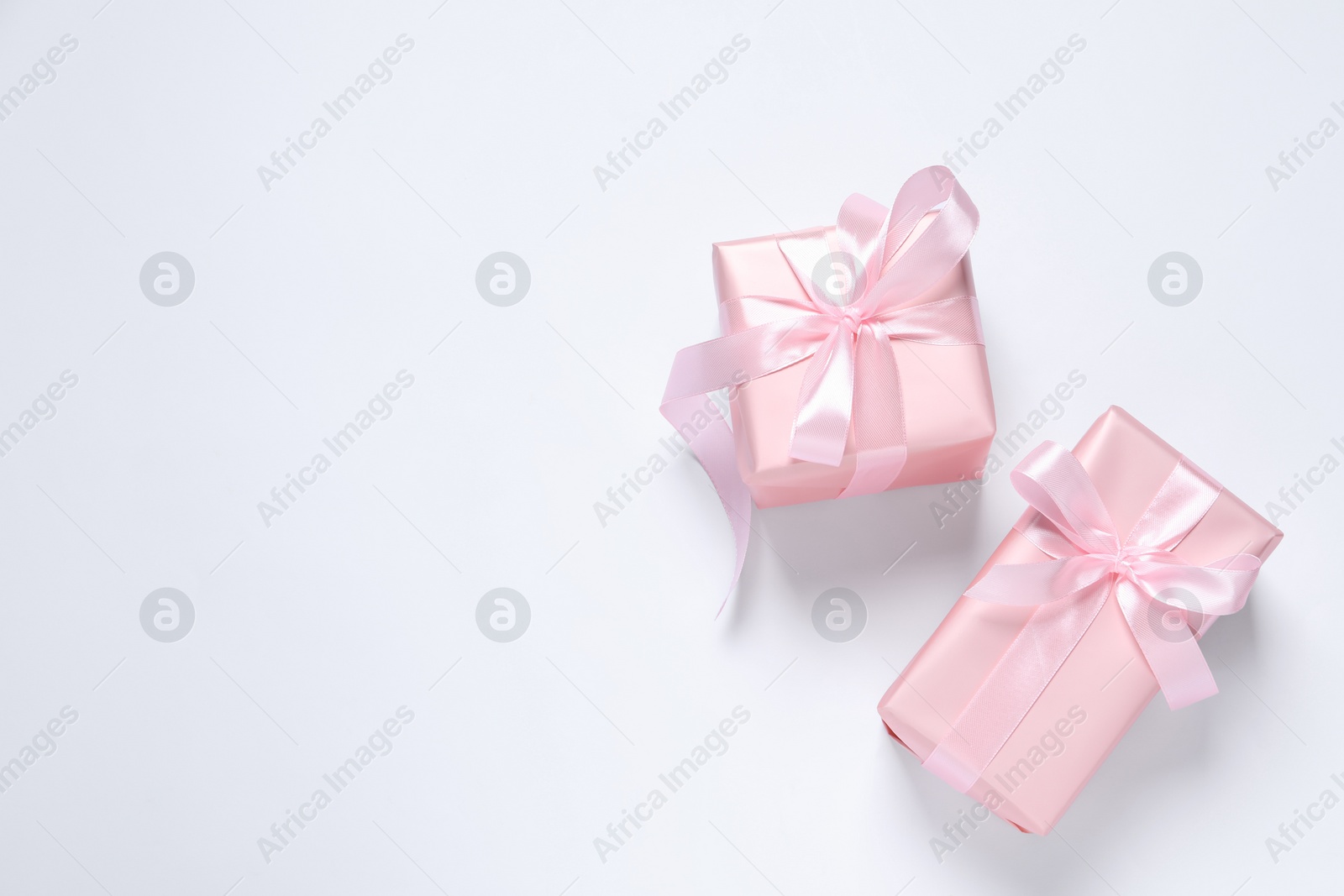 Photo of Beautiful gift boxes on white background, flat lay. Space for text