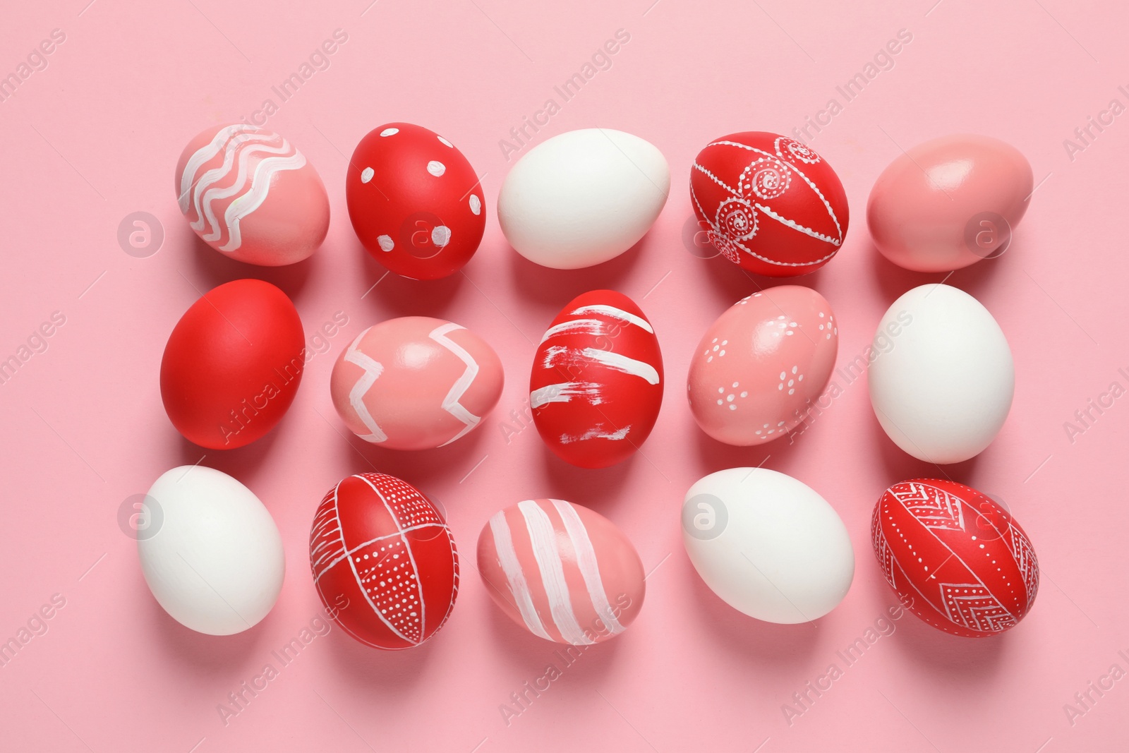 Photo of Flat lay composition of painted Easter eggs on color background