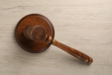 Photo of Wooden gavel on light table, top view