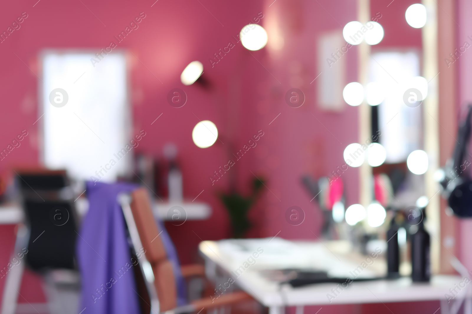 Photo of Blurred view of hairdresser's workplace in salon