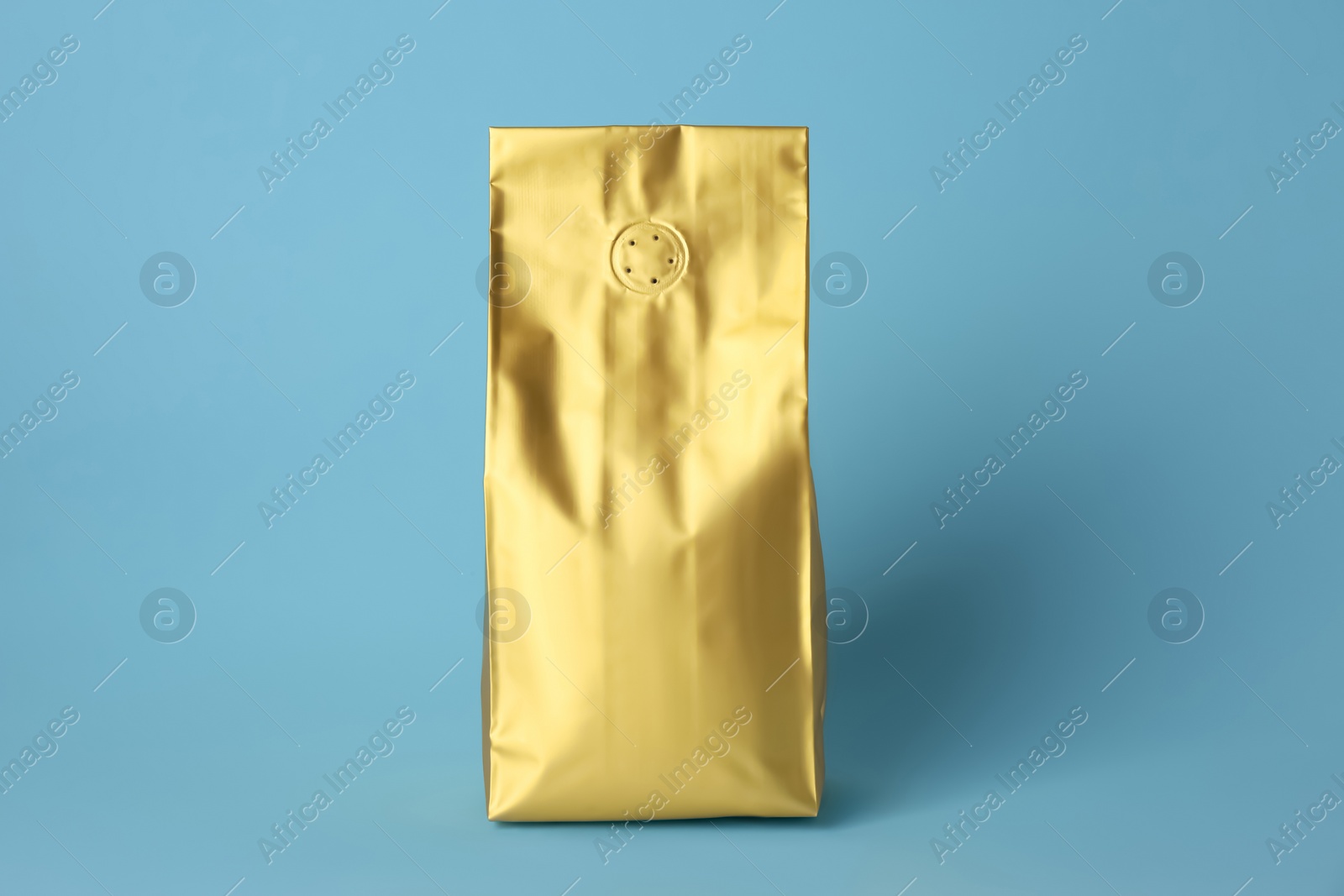 Photo of One blank foil package on light blue background