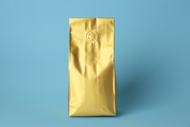 Photo of One blank foil package on light blue background