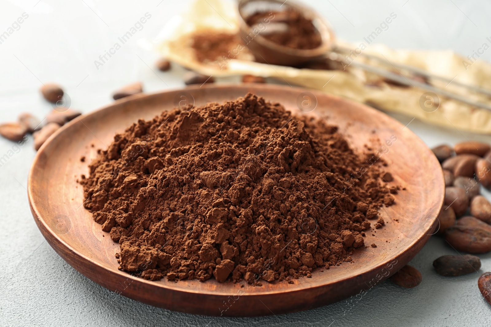 Photo of Plate with cocoa powder on table