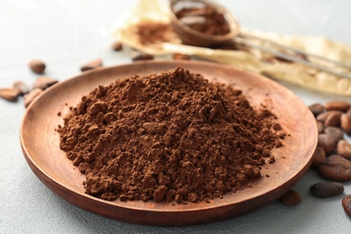 Plate with cocoa powder on table