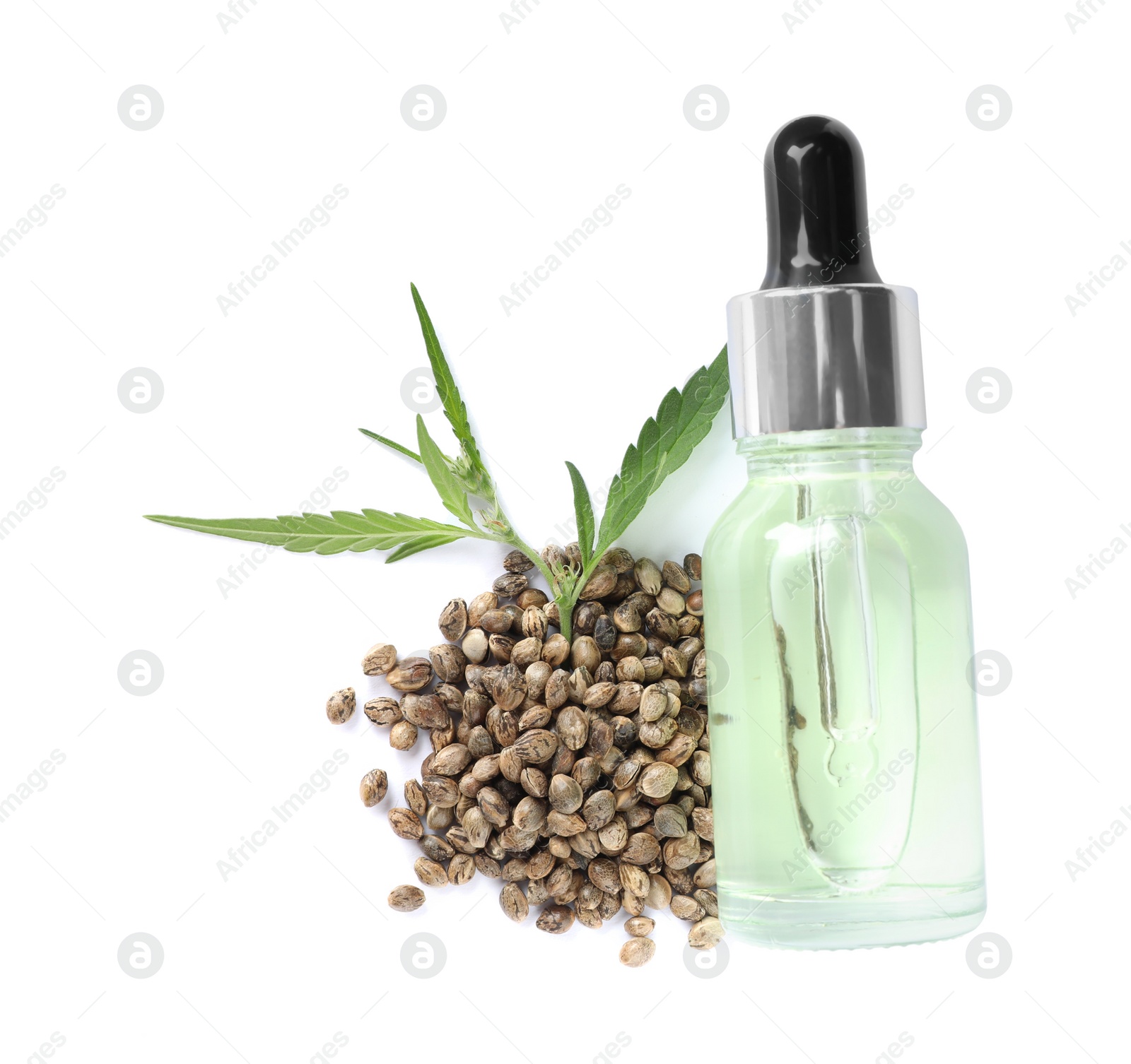 Photo of Hemp essential oil serum, green leaves and seeds on white background, top view. Natural cosmetics