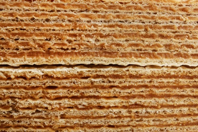 Photo of Delicious crispy wafers as background, closeup view