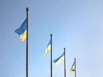 Photo of National flags of Ukraine against clear blue sky