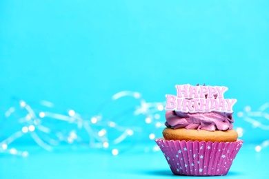 Birthday cupcake on color background