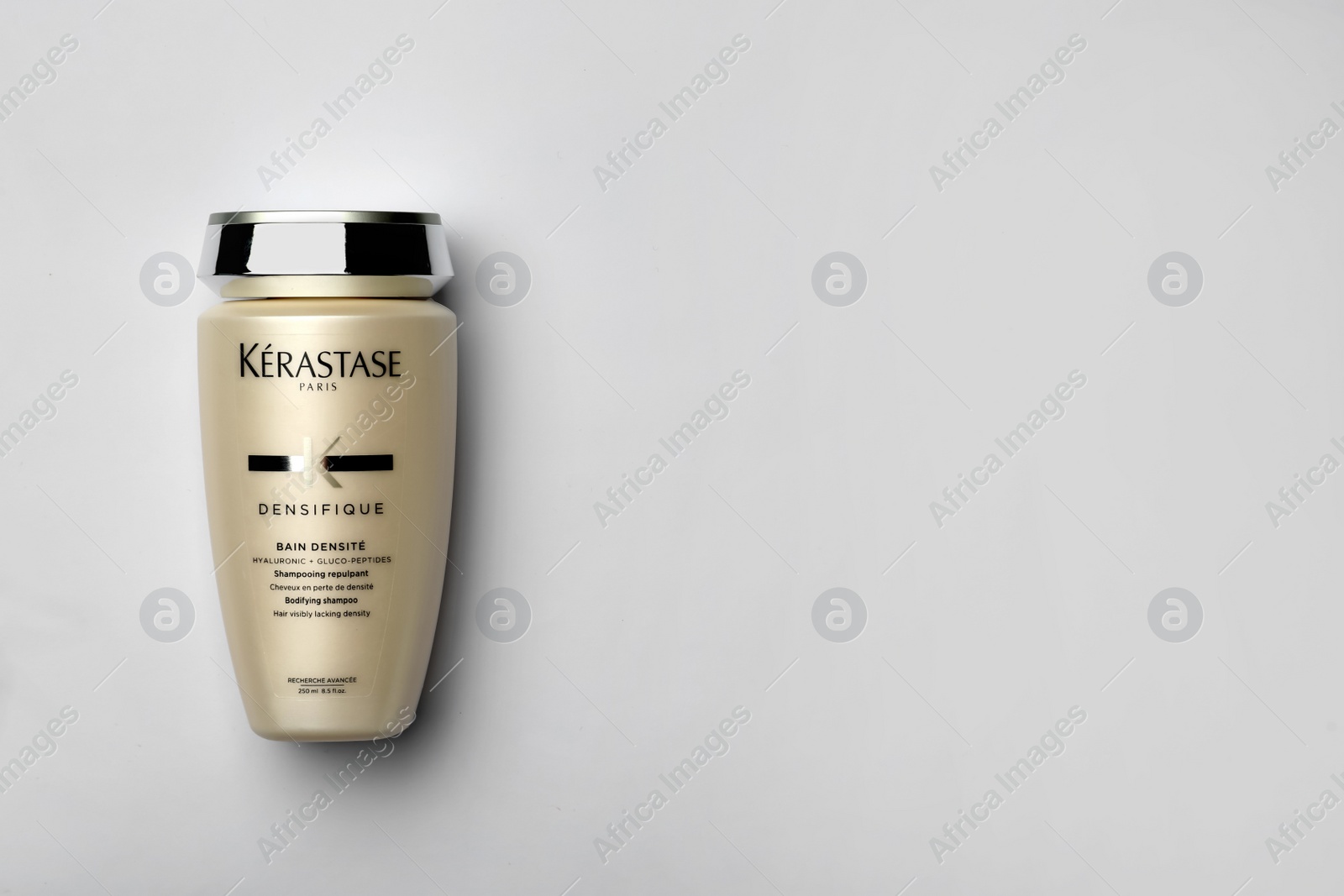 Photo of MYKOLAIV, UKRAINE - SEPTEMBER 07, 2021:  Kerastase shampoo on light background, top view. Space for text