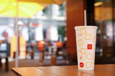 MYKOLAIV, UKRAINE - AUGUST 11, 2021: Cold McDonald's drink on table in cafe. Space for text