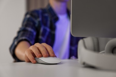 Photo of Teenage boy using computer in room at night, closeup. Internet addiction