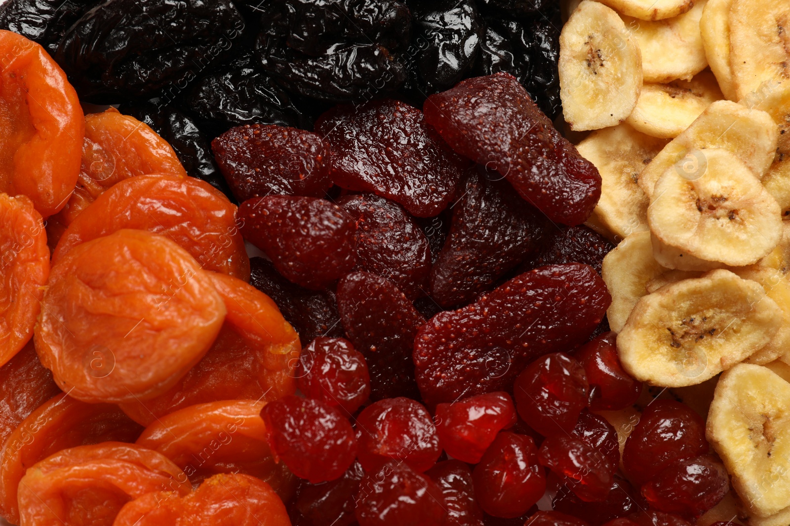 Photo of Different delicious dried fruits as background, top view