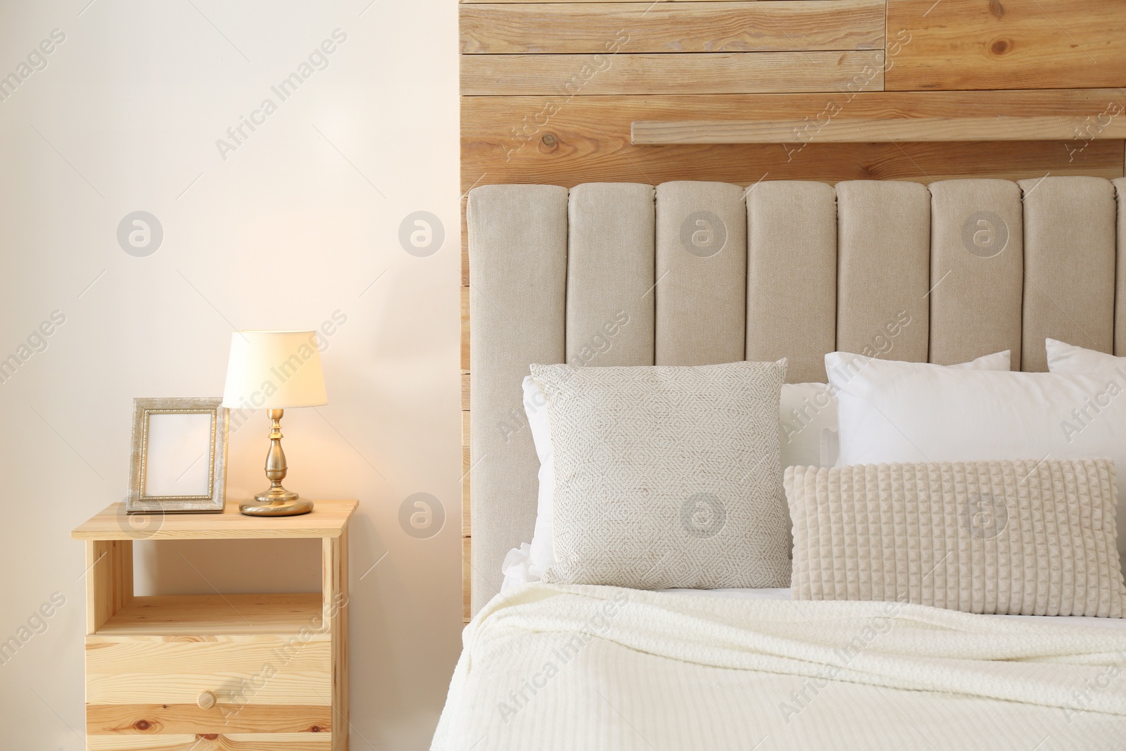 Photo of Comfortable bed with pillows in modern room interior